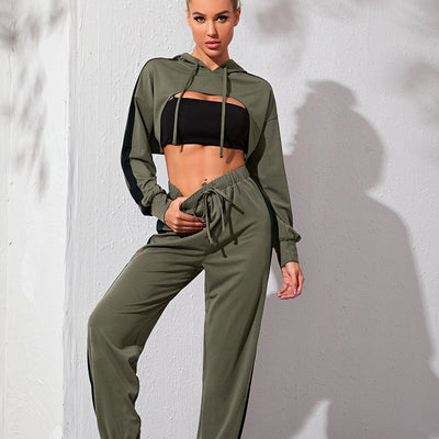 Woman wearing a green tracksuit with a cut-out design on a white background